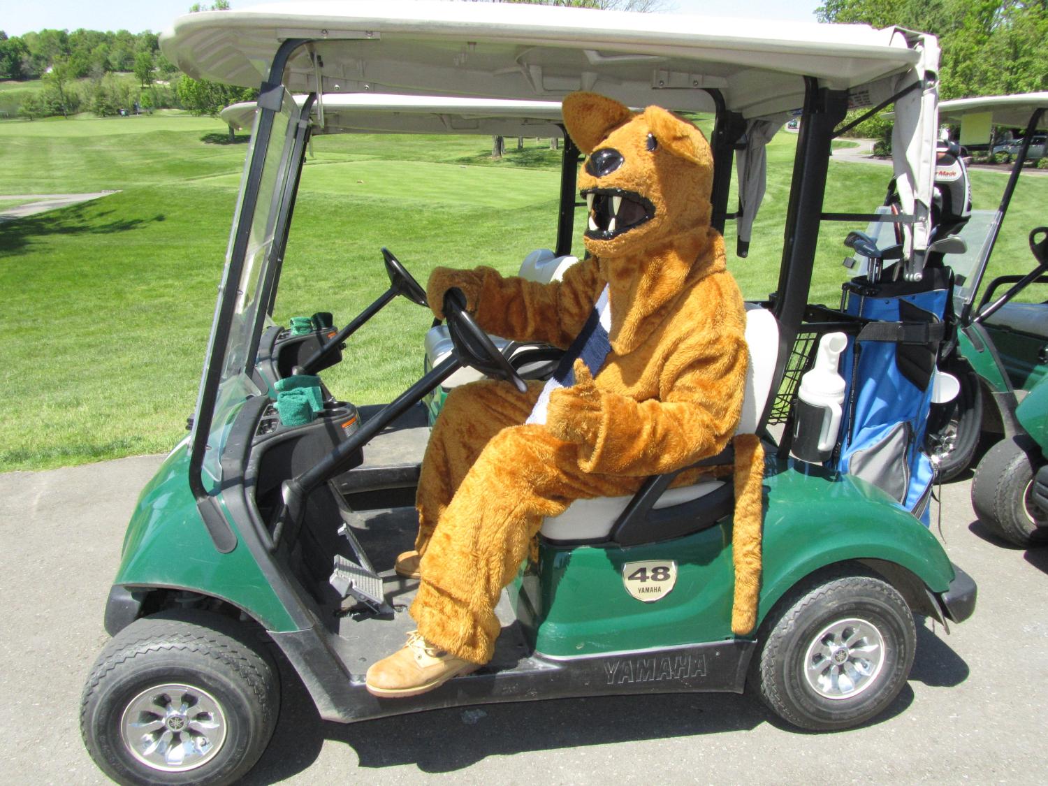Nittany Lion driving golf cart at last year's tournament