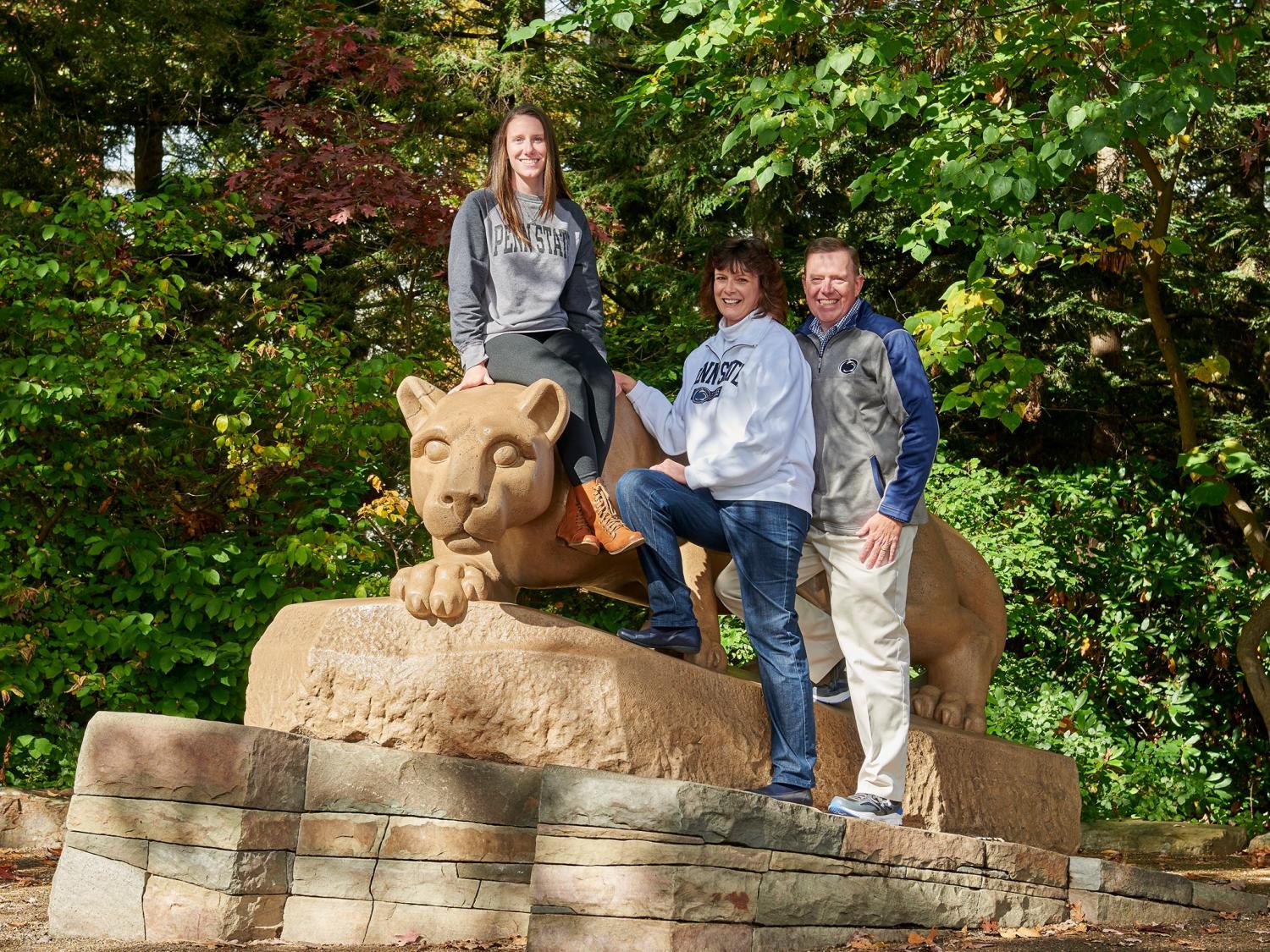 Penn State student and family posing at the lion shrine