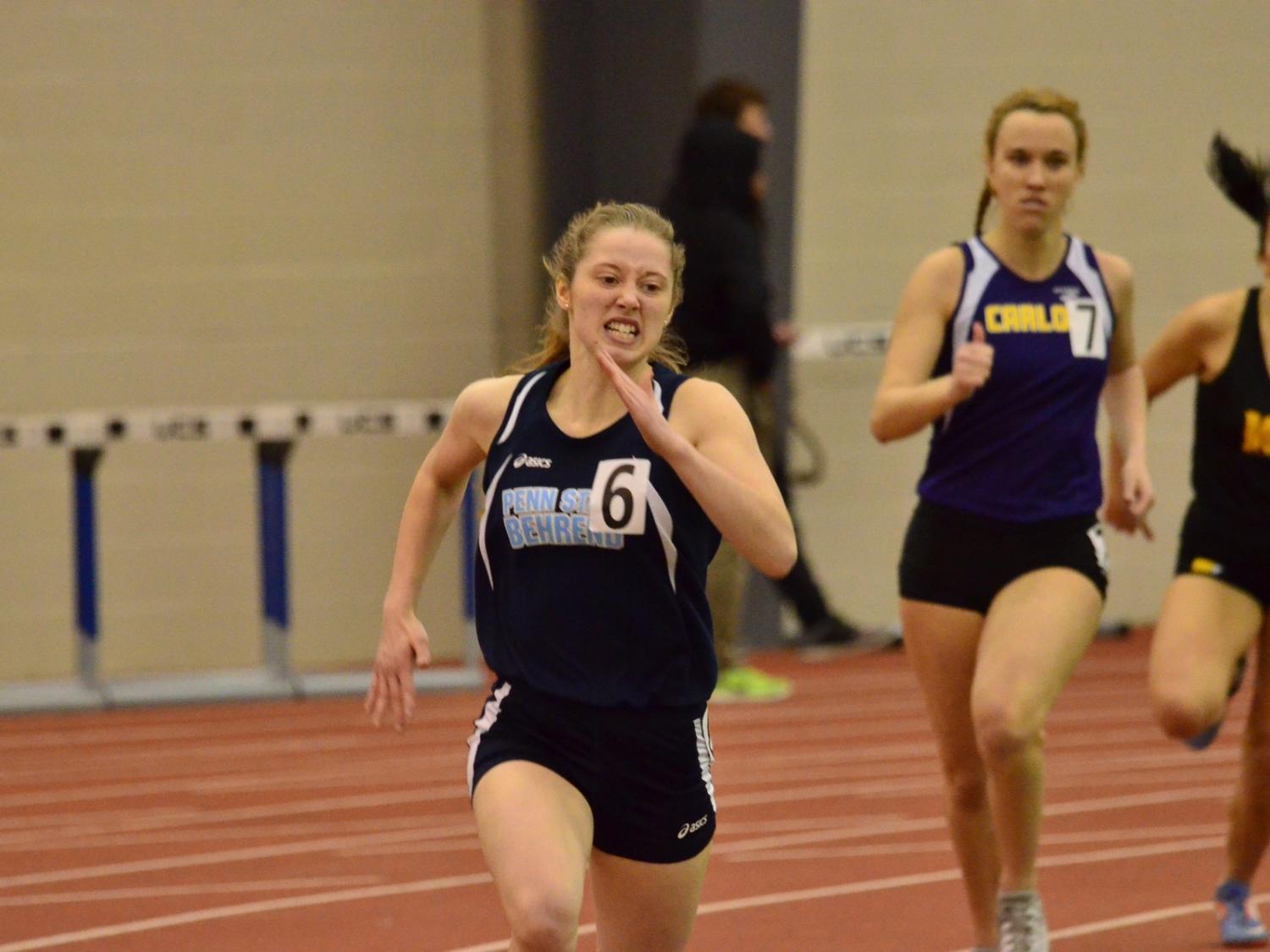 A Penn State Behrend runner competes in an indoor race.