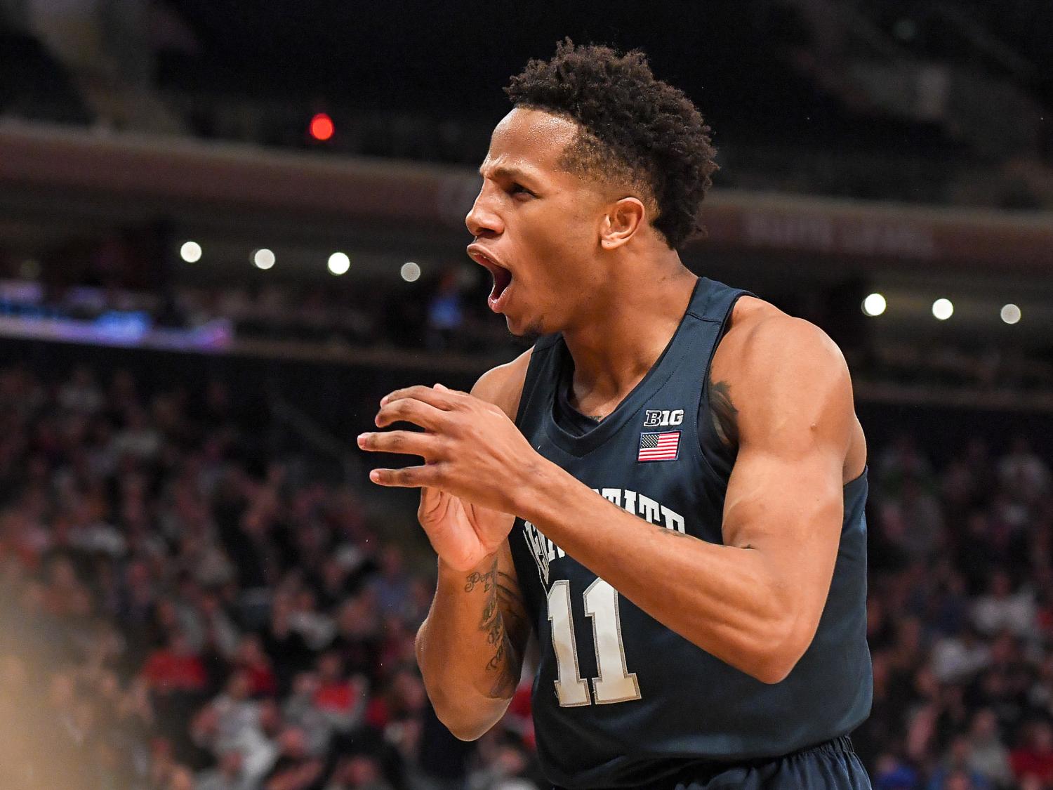 man in blue basketball jersey clapping hands enthusiastically