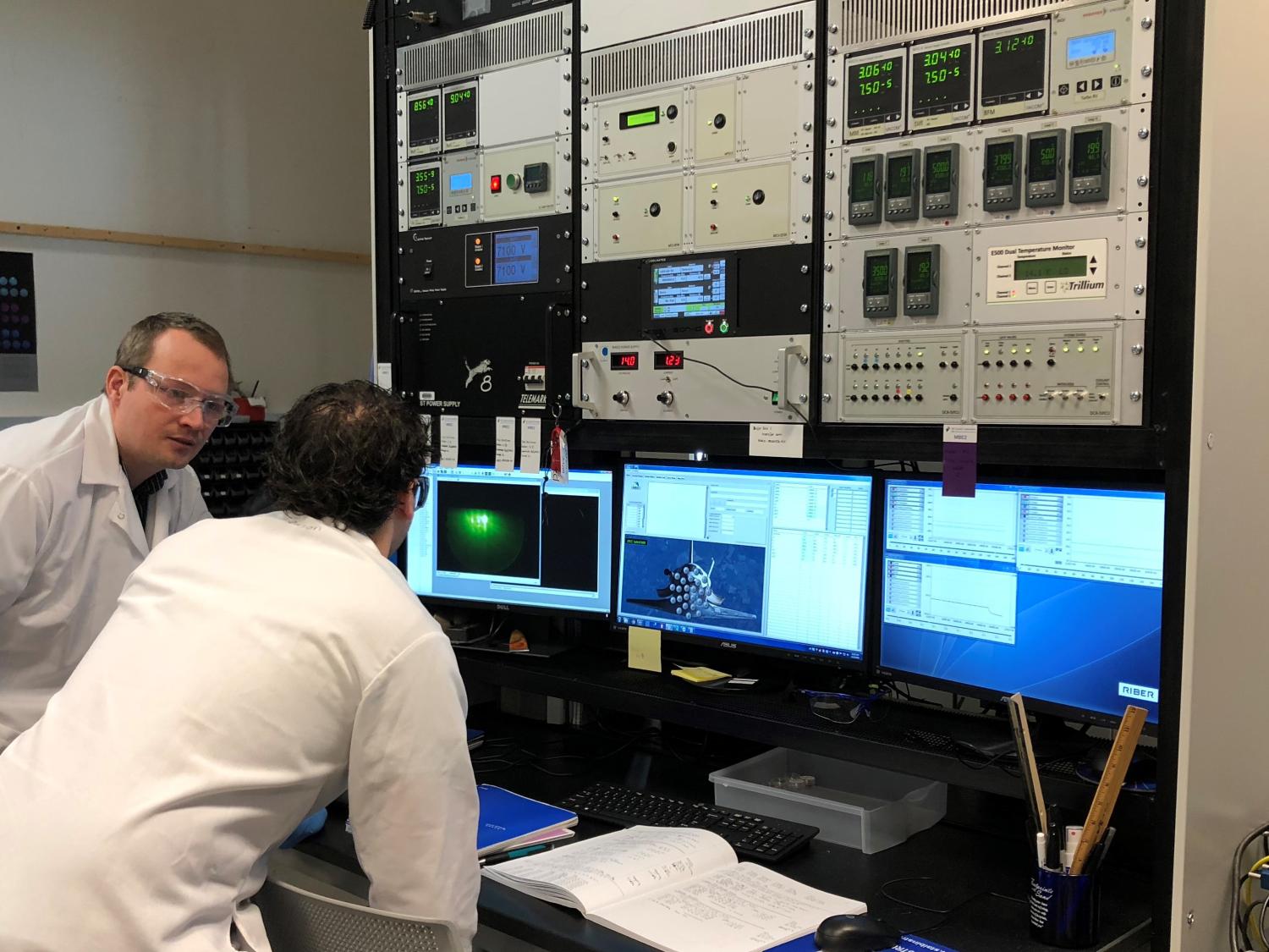 Two men reviewing information on computer screen