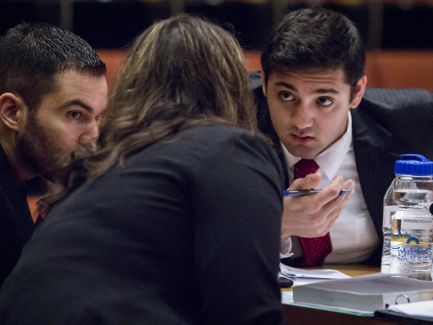 First-year Dickinson Law student Nader Amer consults with Penn State Children's Hospital pediatric resident Nathan McConkey and second-year law student Emily Paul. 