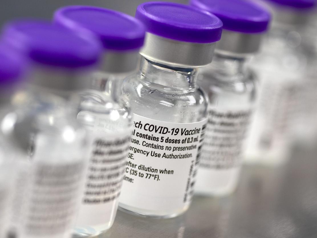 Vials of COVID-19 vaccine are lined up in a laboratory.