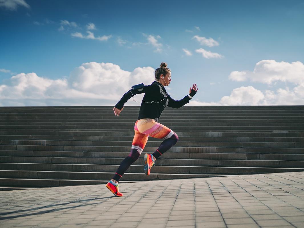 A woman runs outdoors.