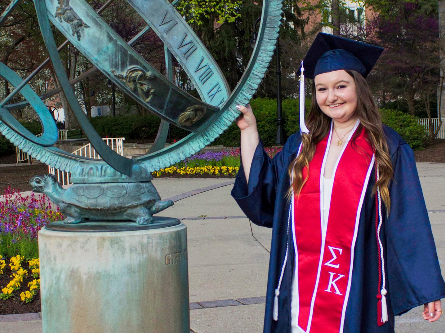 Shannon Magee with sculpture on Old Main patio