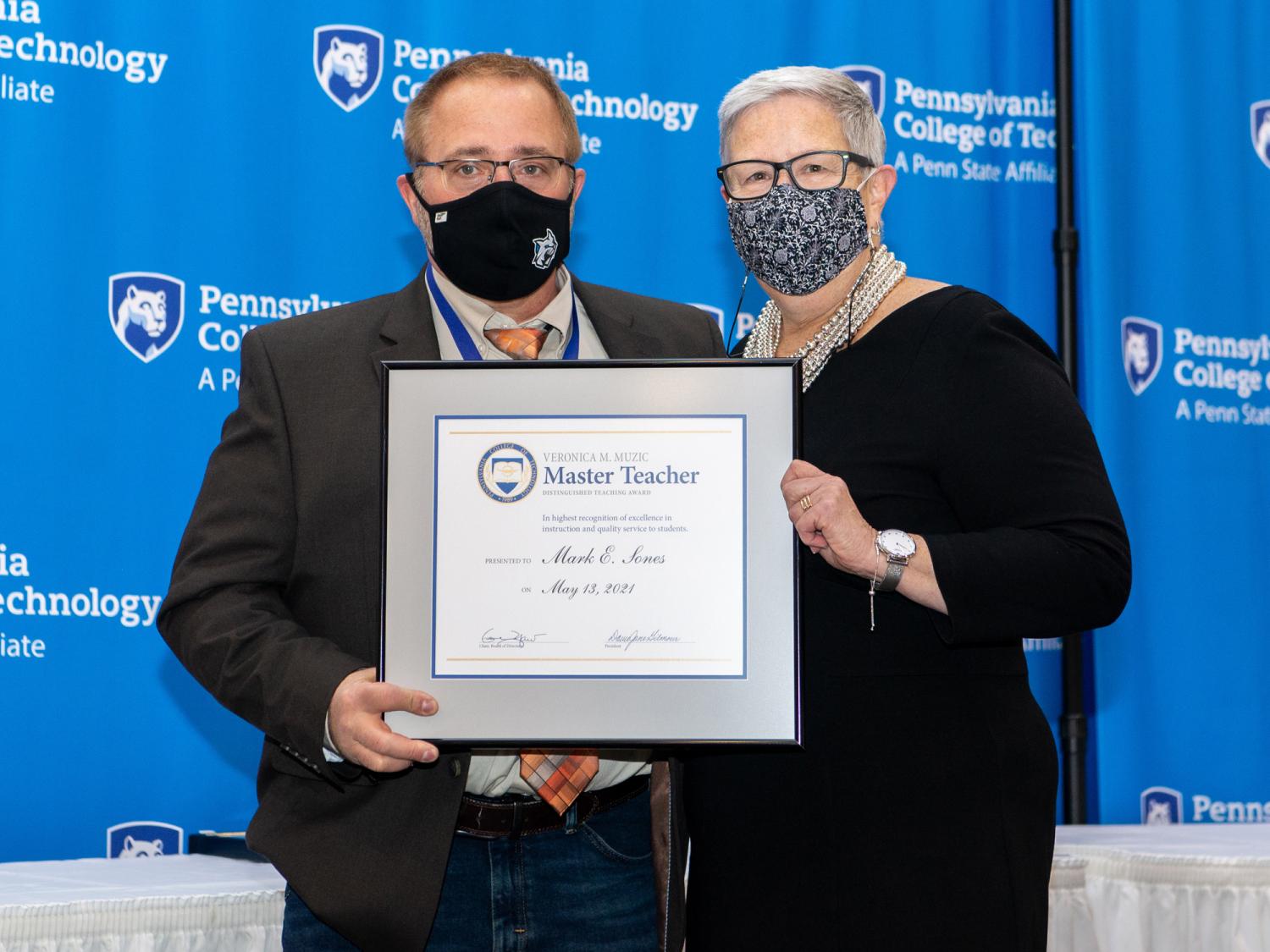 Mark Sones, left, receives an award from Davie Jane Gilmour