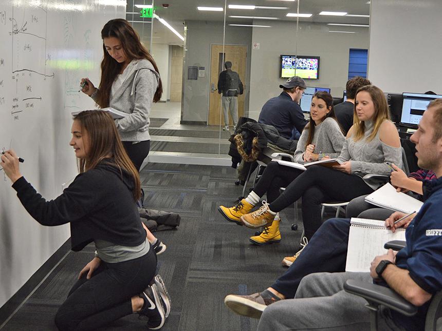 students study at whiteboard wall