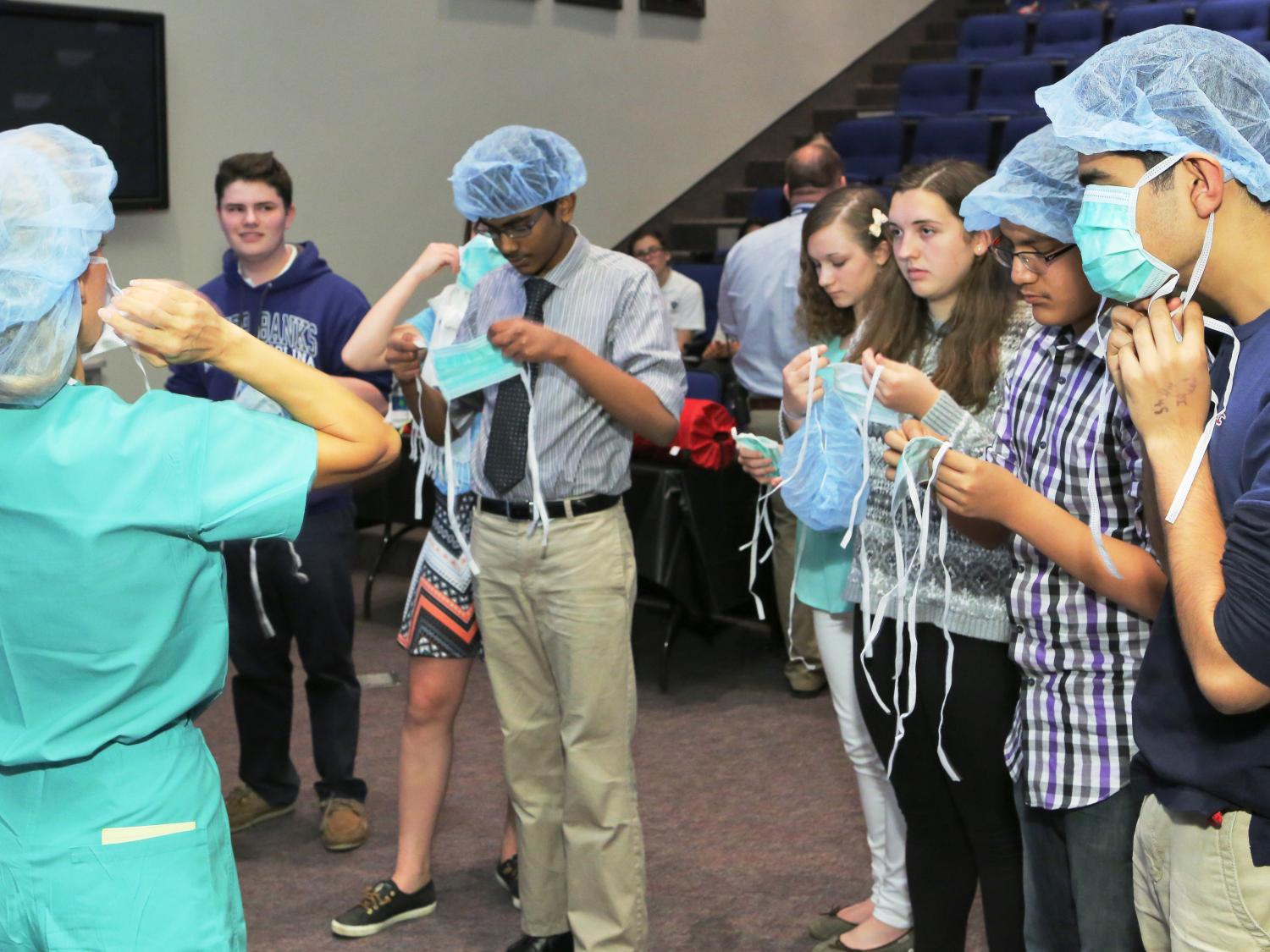 Students put on surgical caps and masks.