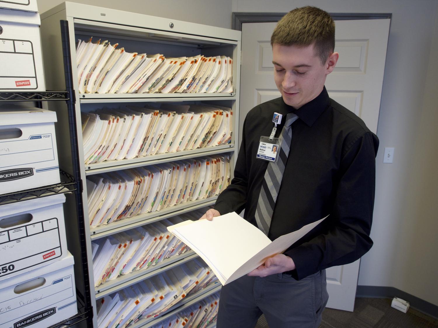 young man examining a file