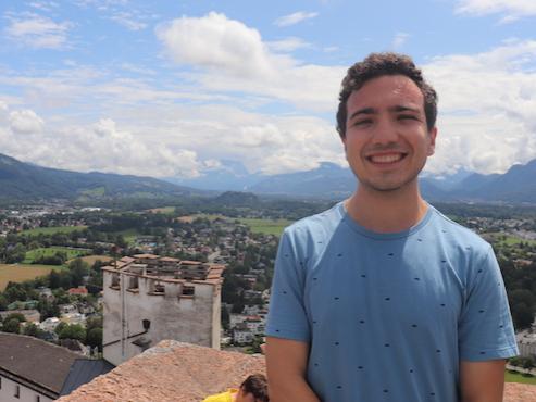 Man standing on an overlook with the Austrian countryside behind him. 