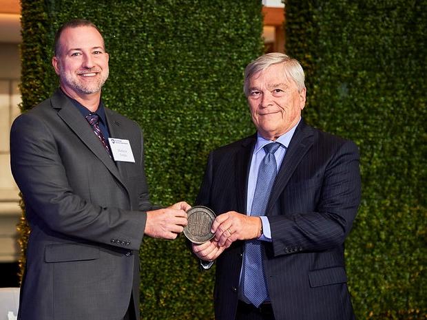 Matthew Totzke receives the Penn State Alumni Fellow Award from Penn State President Eric Barron