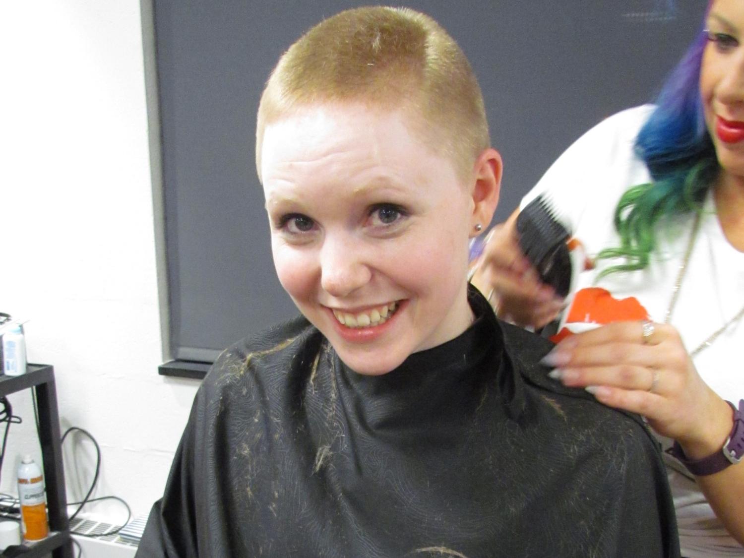 Student Amber Metzger goes under the shears to have her head shaved for THON. 