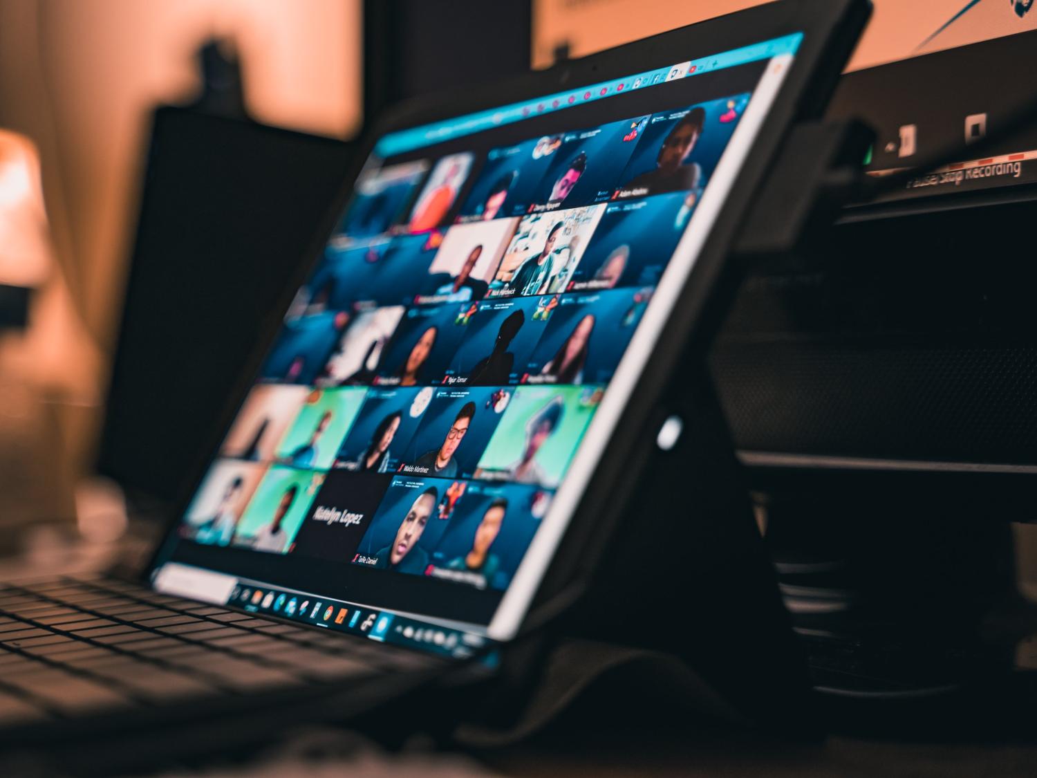 photo of a laptop with a video conference call on the screen