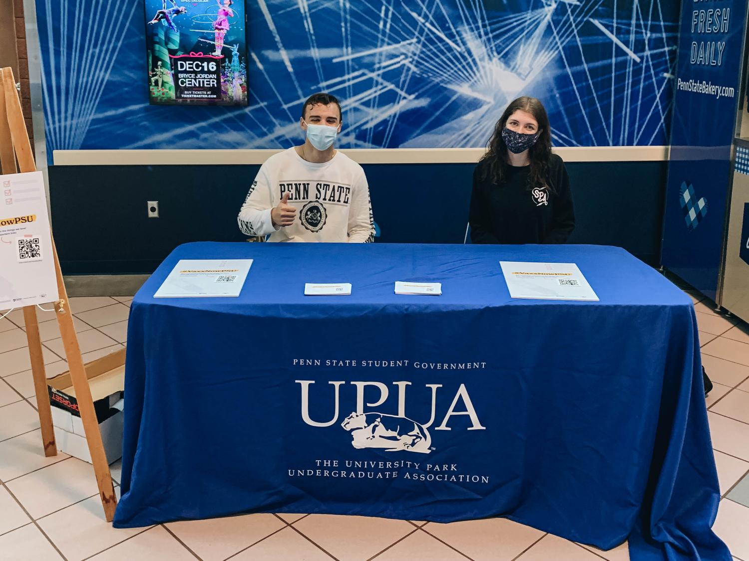 two students sit at a UPUA table
