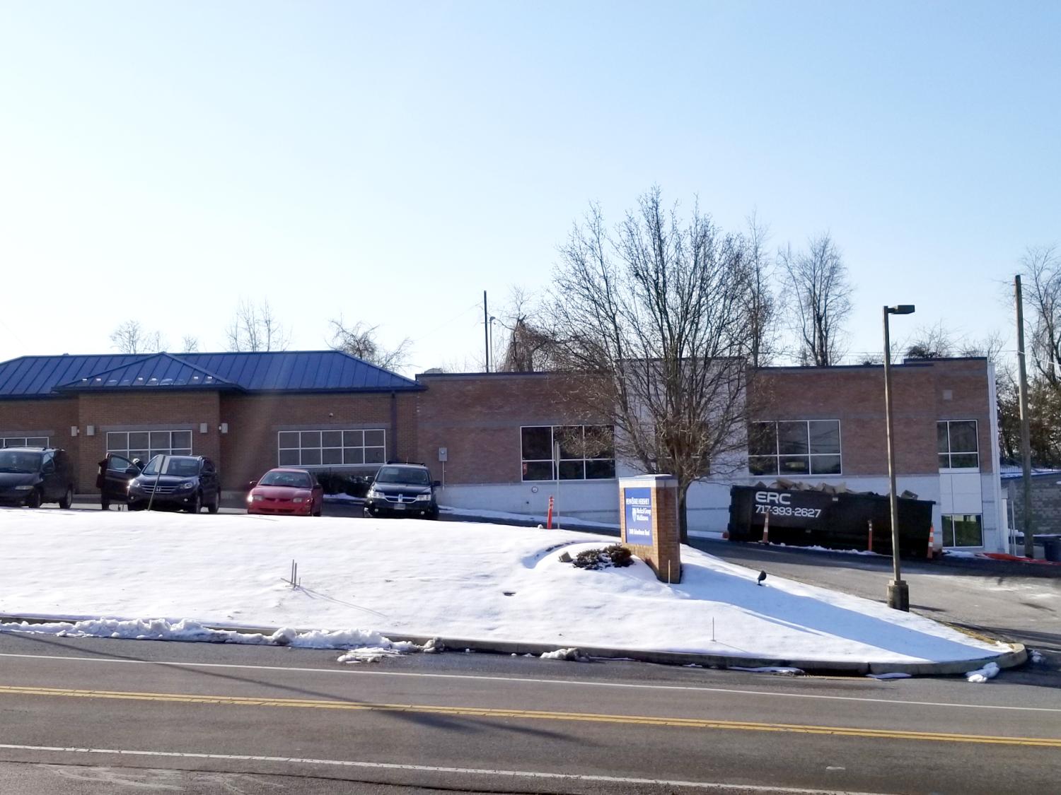 A two story medical building is shown on a snowy road.