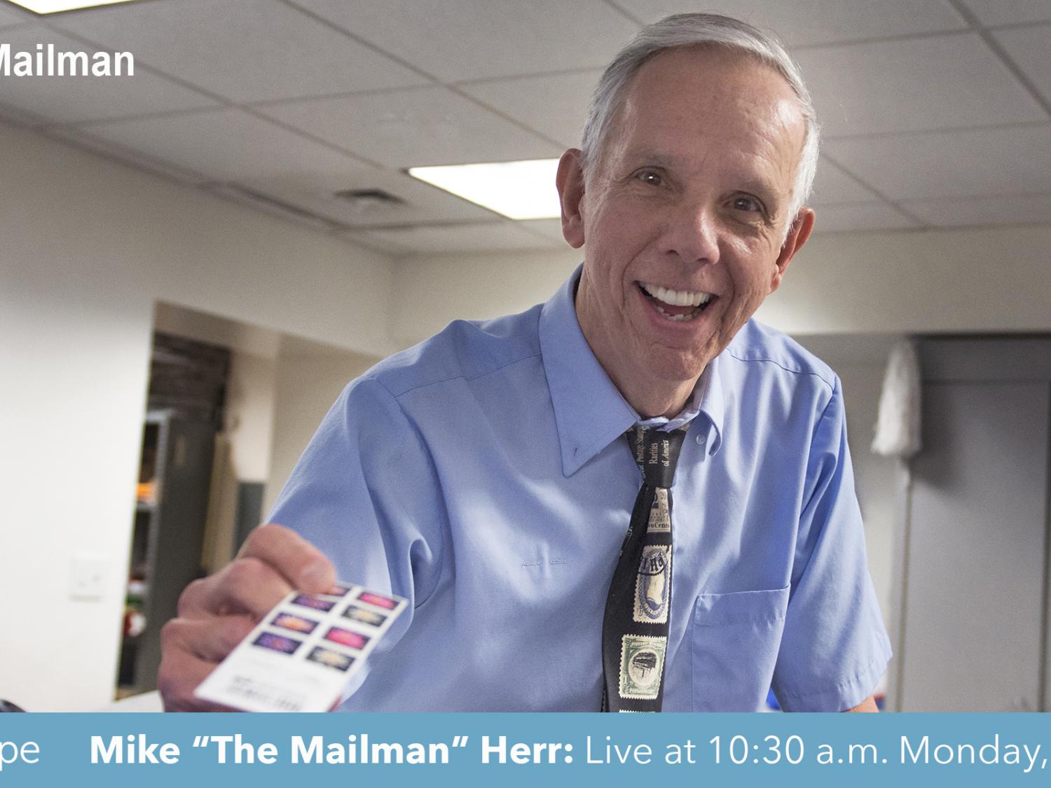 Mike the Mailman holding stamps