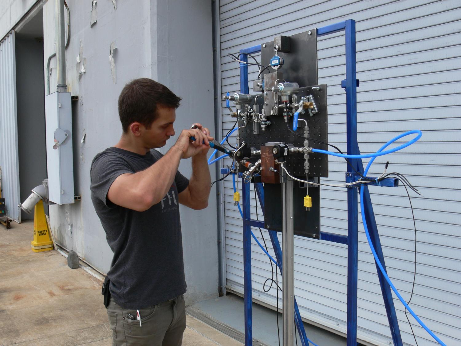 Michael Policelli, of the Lunar Lion team, working on a test plate at the Applied Research Laboratory.
