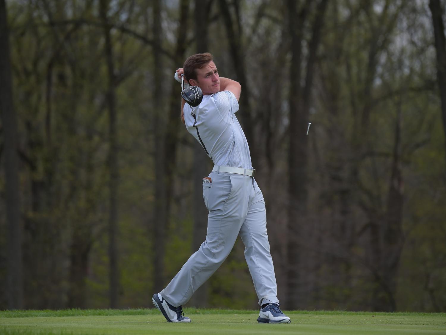 man swinging a golf club on tee shot