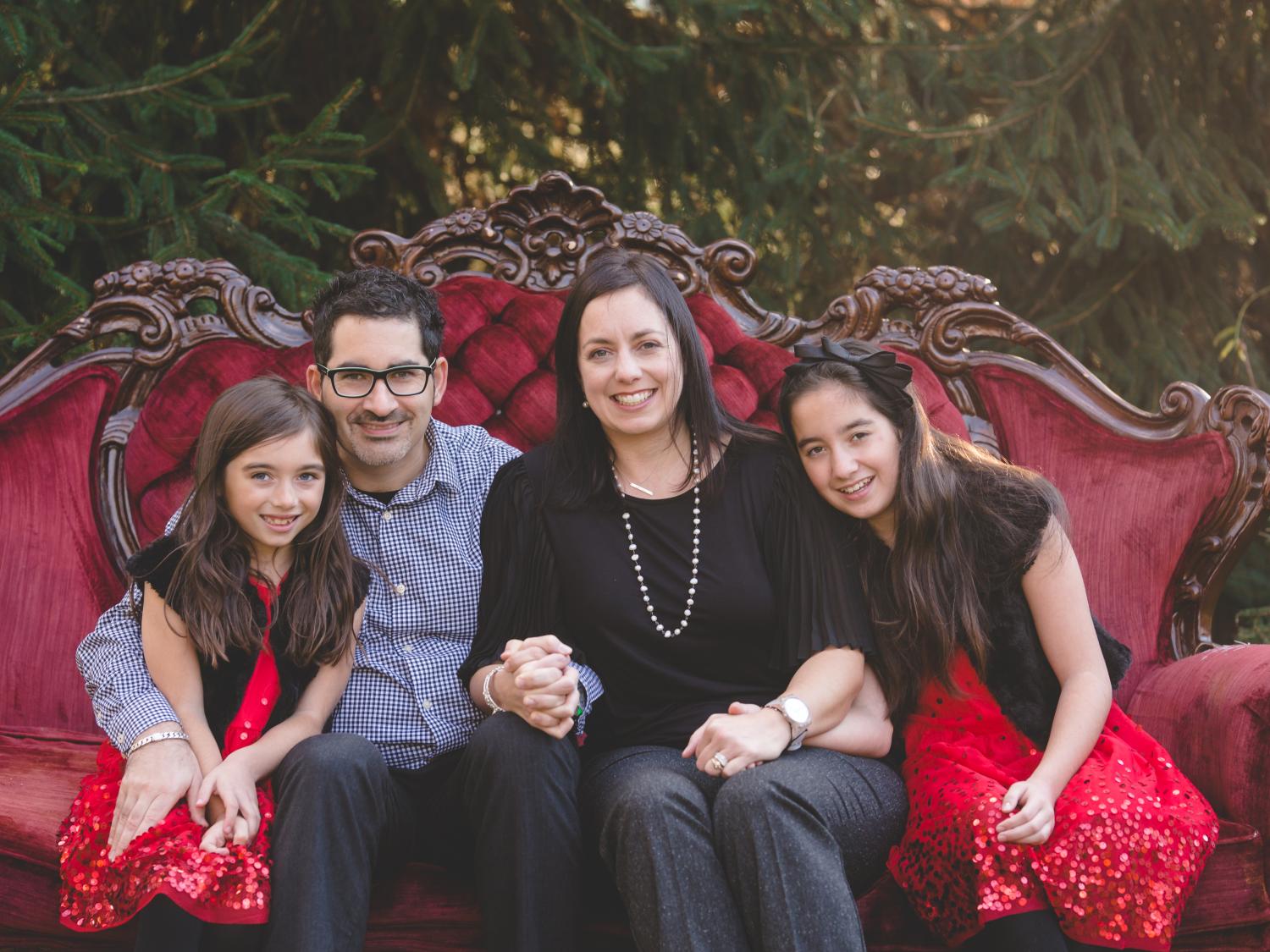 A family of four smiles for a photo.