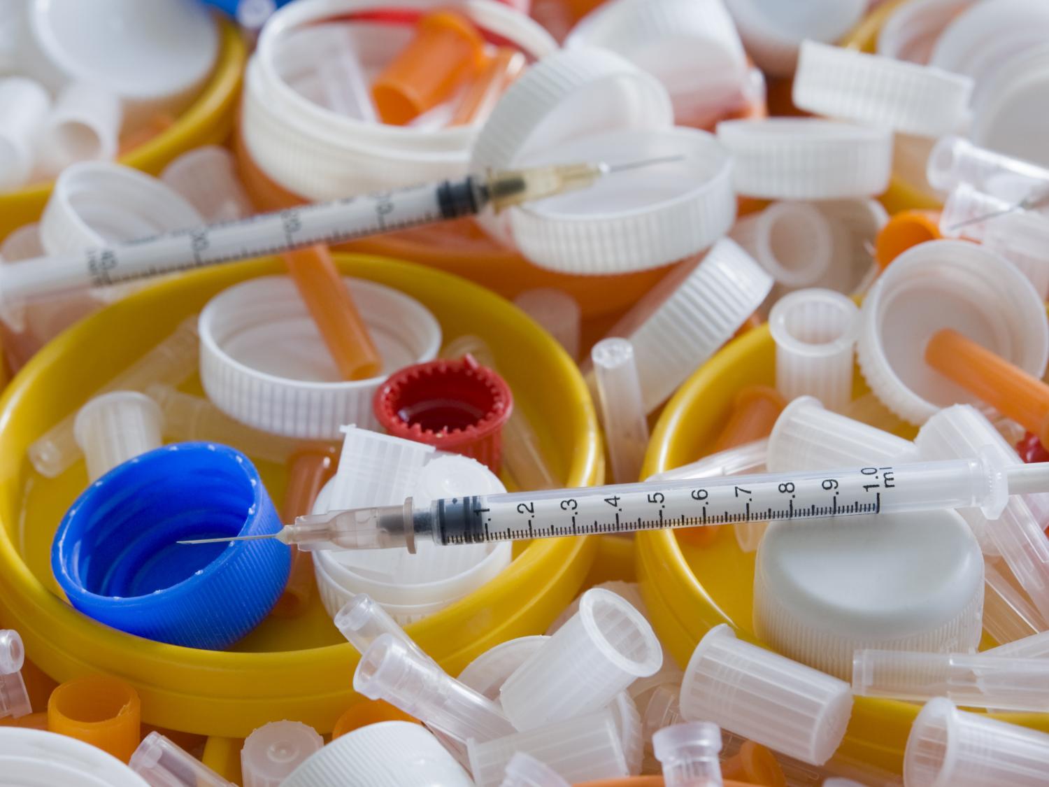 A pile of syringes and related accessories.