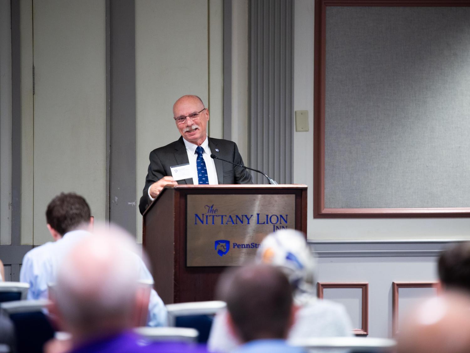 A man stands at a podium