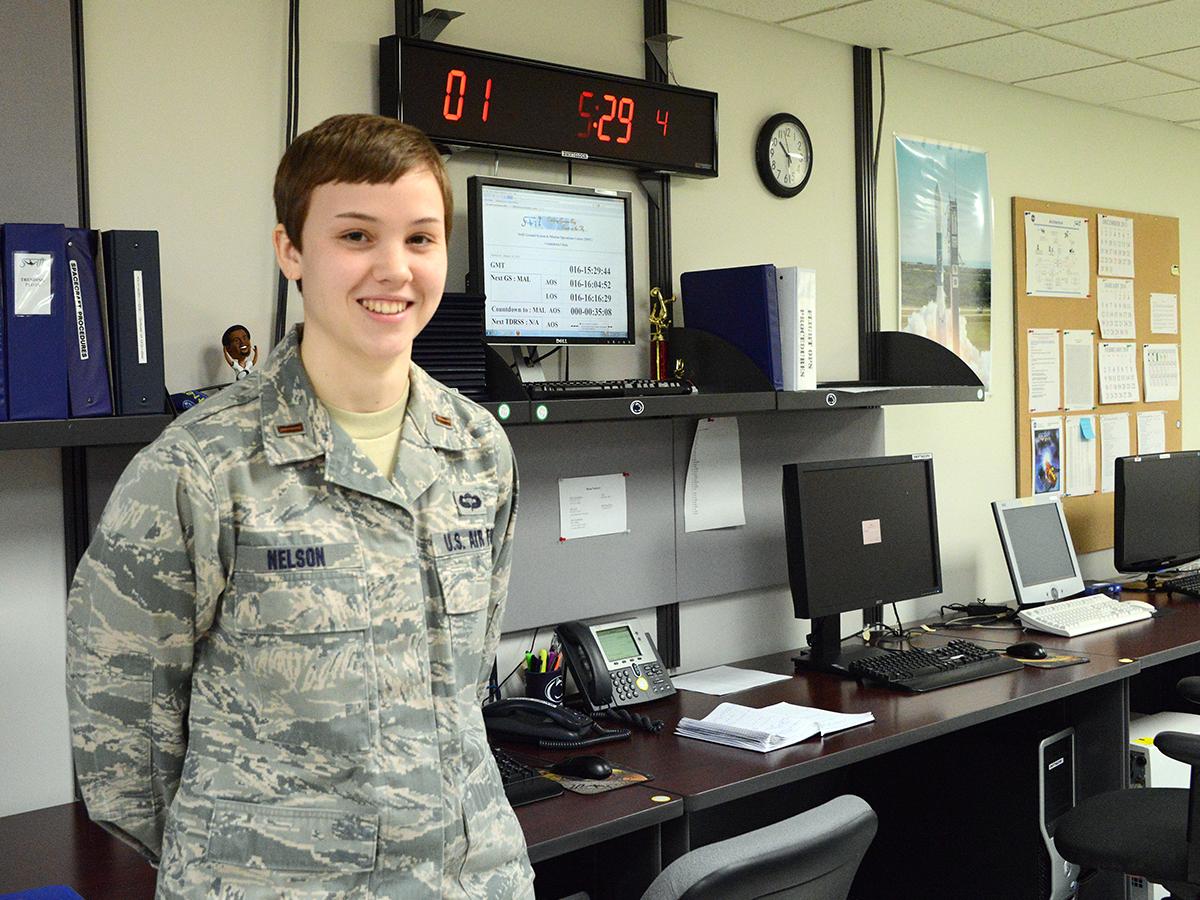 Heather Nelson poses in front of computers