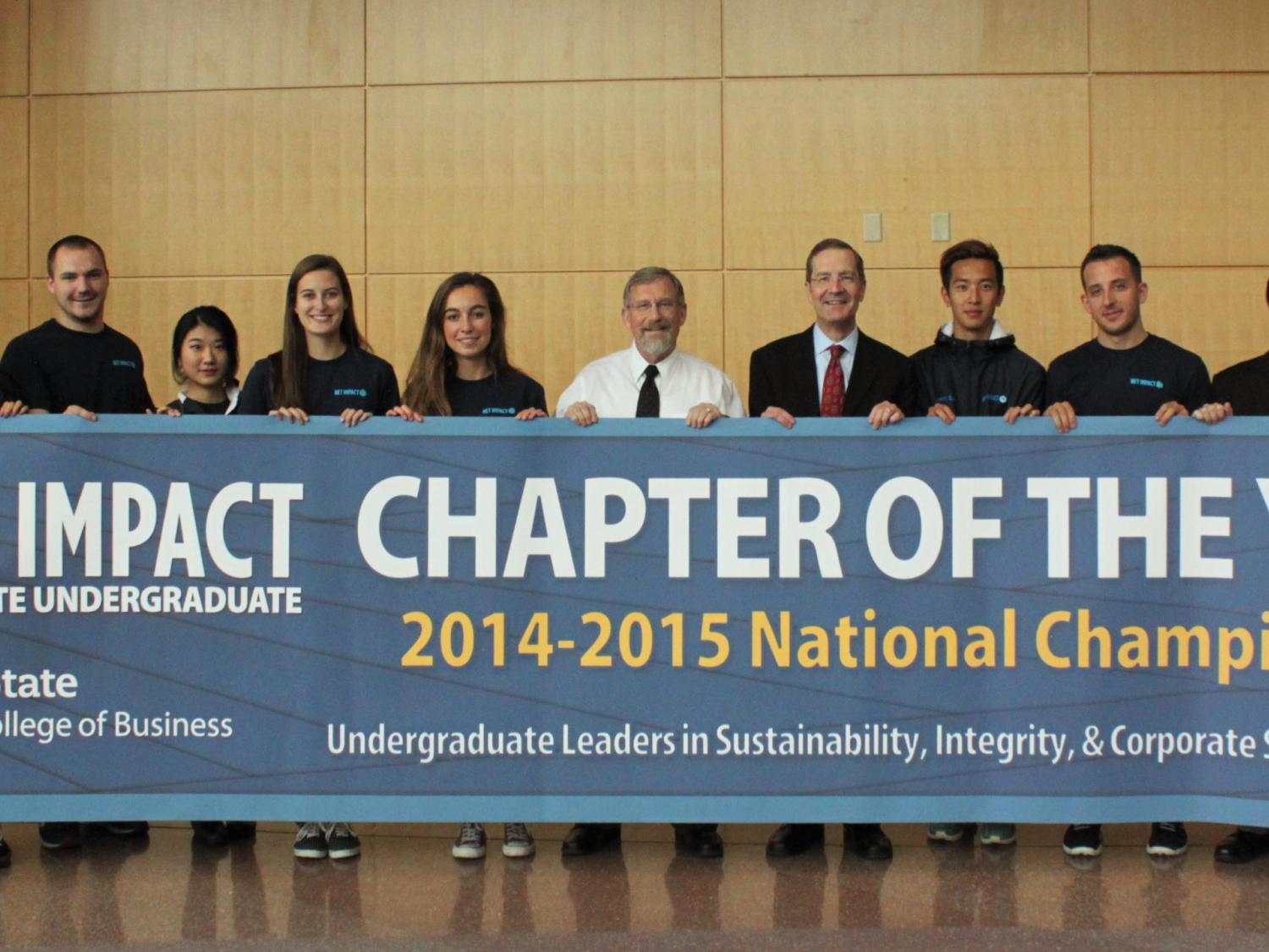 Members of Smeal's Net Impact undergraduate chapter reveal their national championship banner.