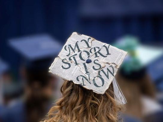 A close-up of a decorated mortarboard cap during a Penn State Behrend commencement program.