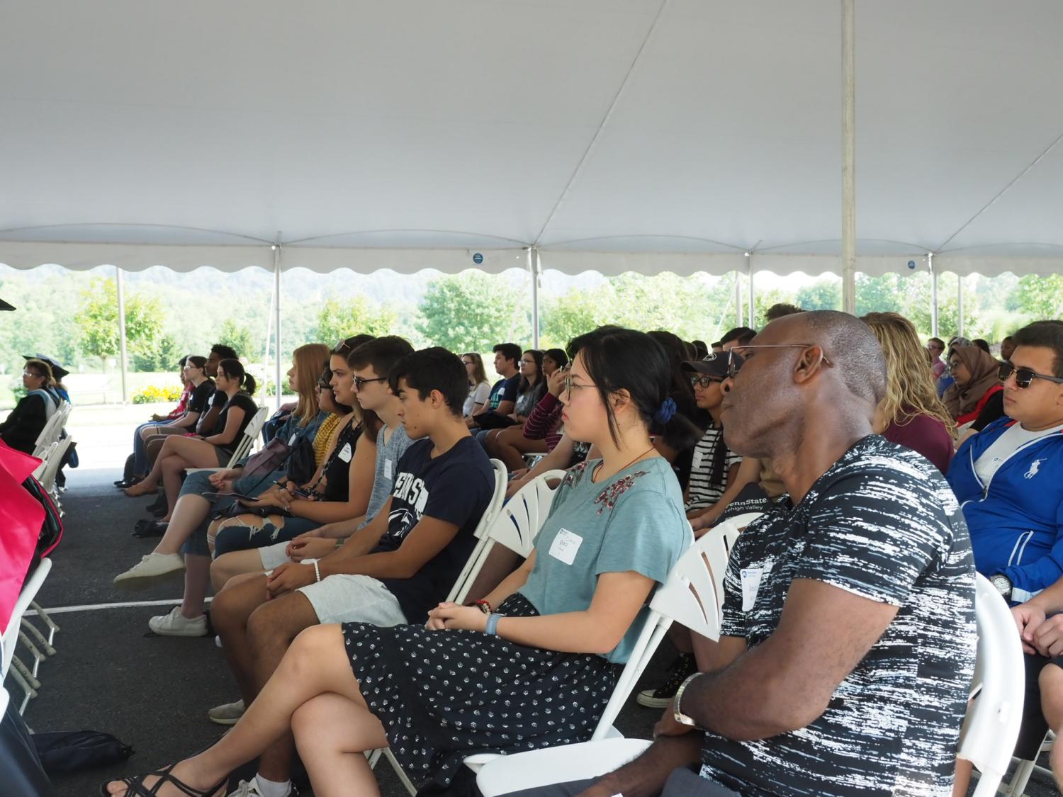 group of students sitting listening to speakers