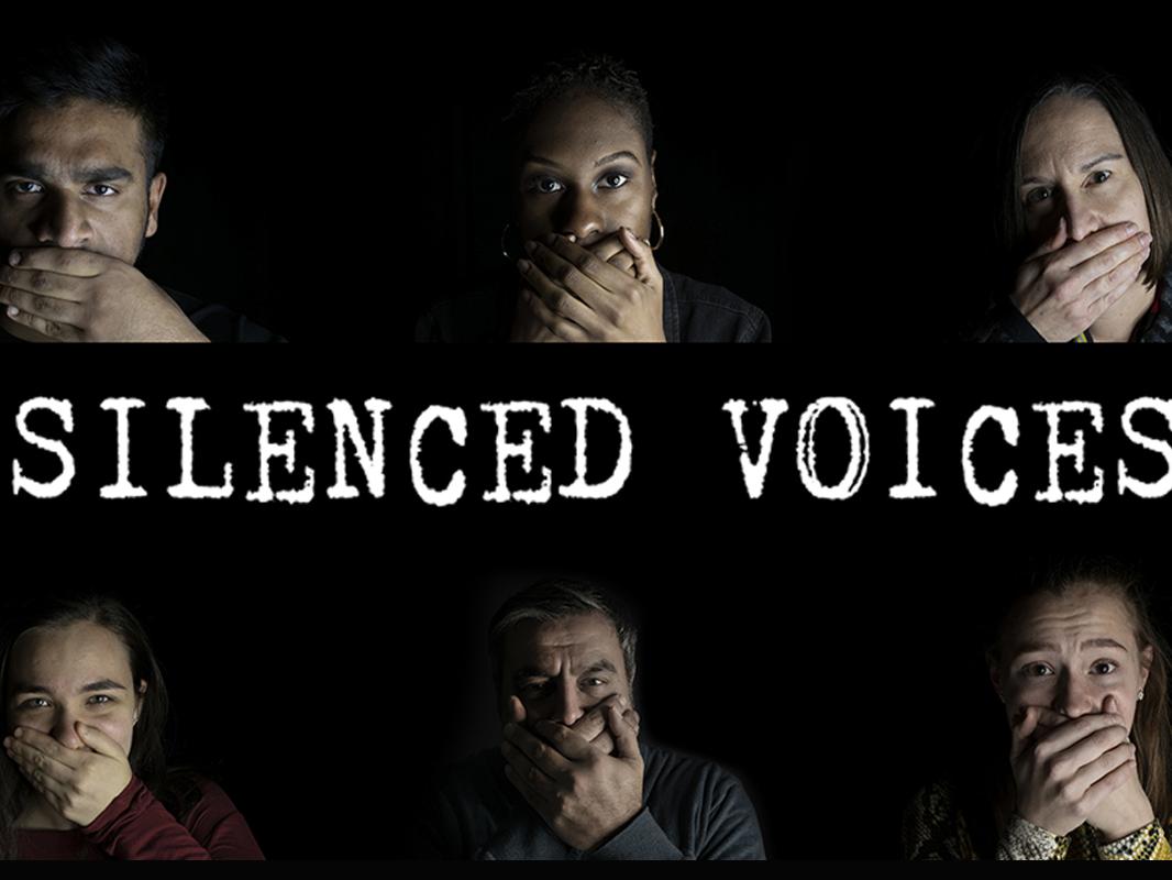 six people with hands covering their masks