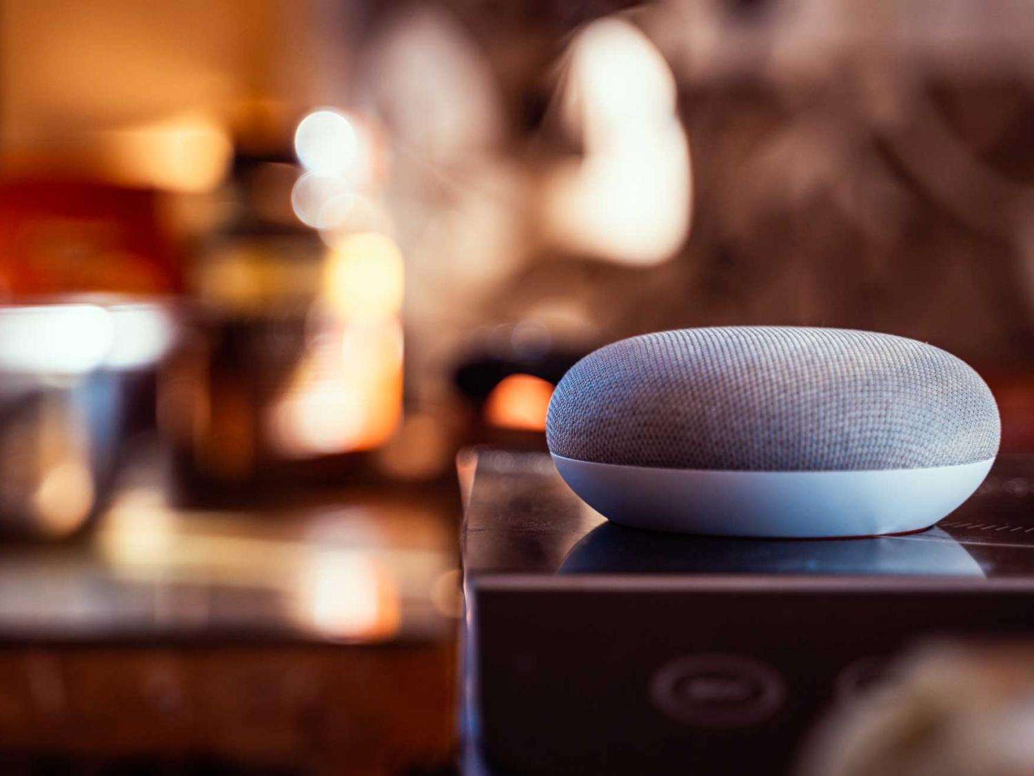 A Google Home smart device sits on a surface.