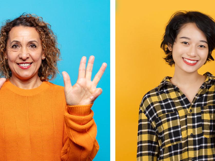 Two women demonstrate hand gestures for the number nine, one in American culture and one in Chinese.