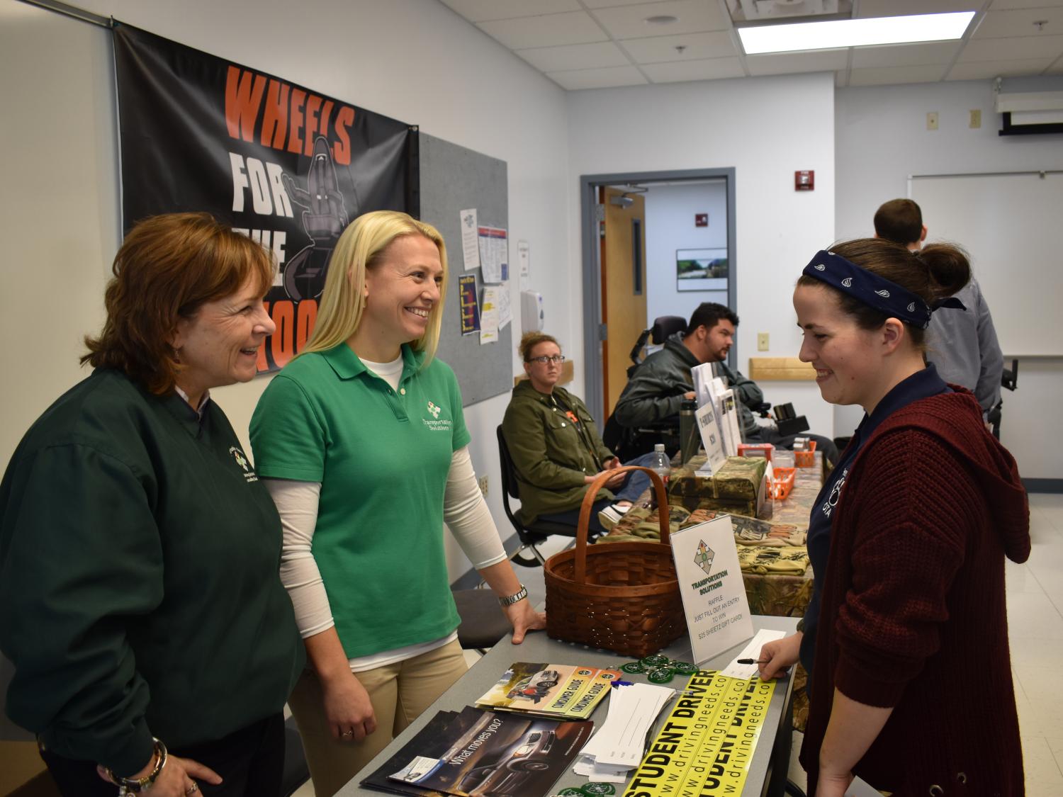 Vendors and students interact at the Assistive Technology Fair. 