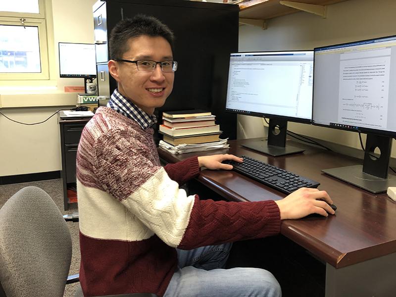 Wei Zhang coding for his research.