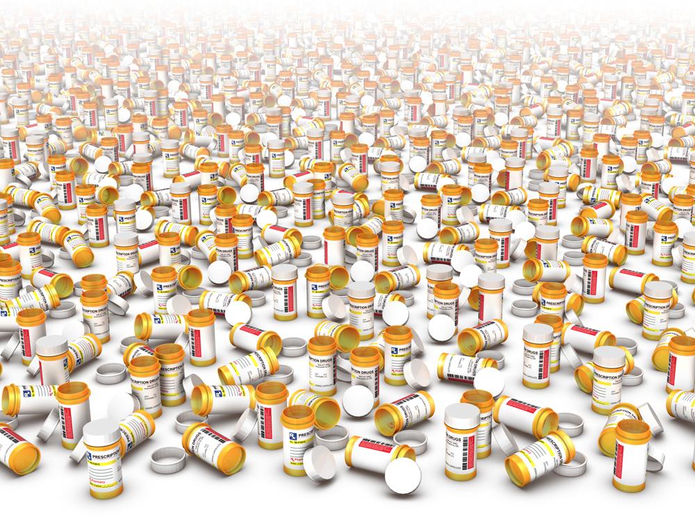 A couple hundred small pill bottles are placed at random, some with lids on, some with lids off. The top of the image fades to white.