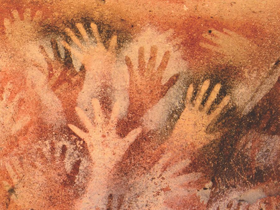 spatter painting of hands on cave wall