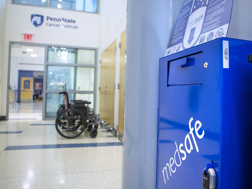 A box with the word “medsafe” written diagonally across the front sits in a hallway outside the Penn State Cancer Institute.