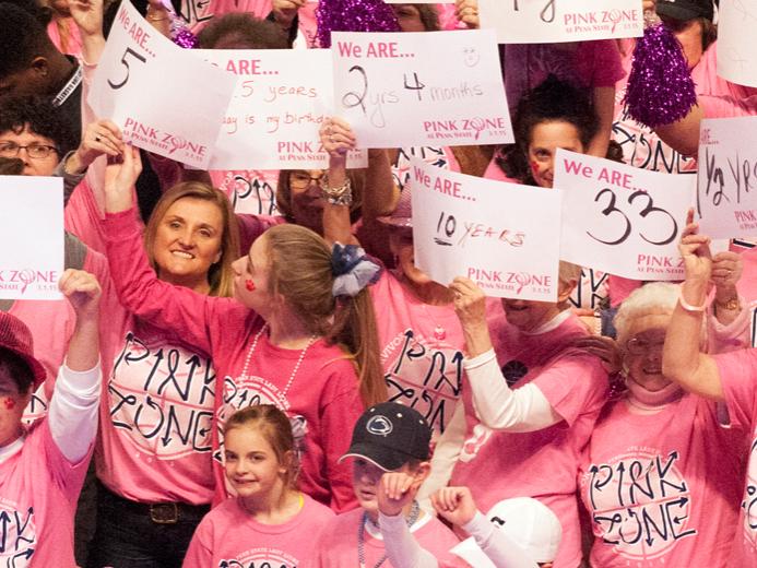 Breast cancer survivors held up signs during halftime festivities showing how long they've been cancer free at the 9th annual Pink Zone at Penn State basketball game held Mar. 1 at the Bryce Jordan Center.