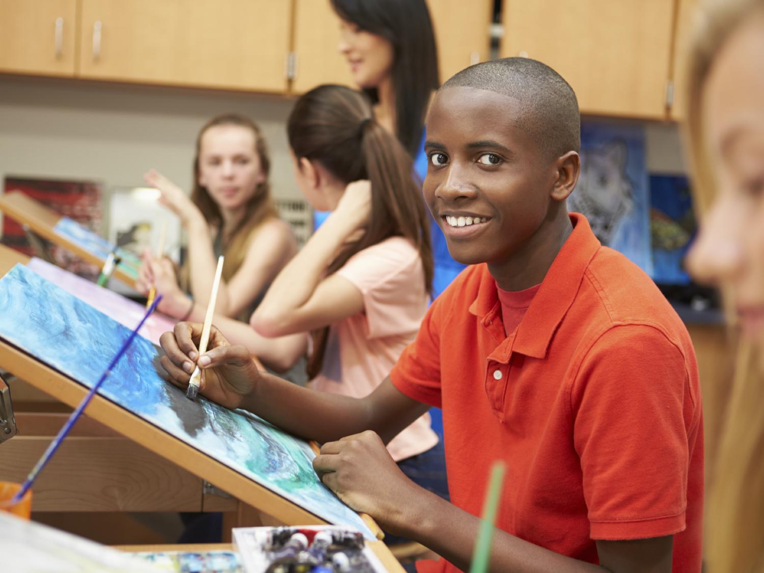 male student in art class