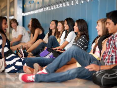 middle school students sitting in hallway