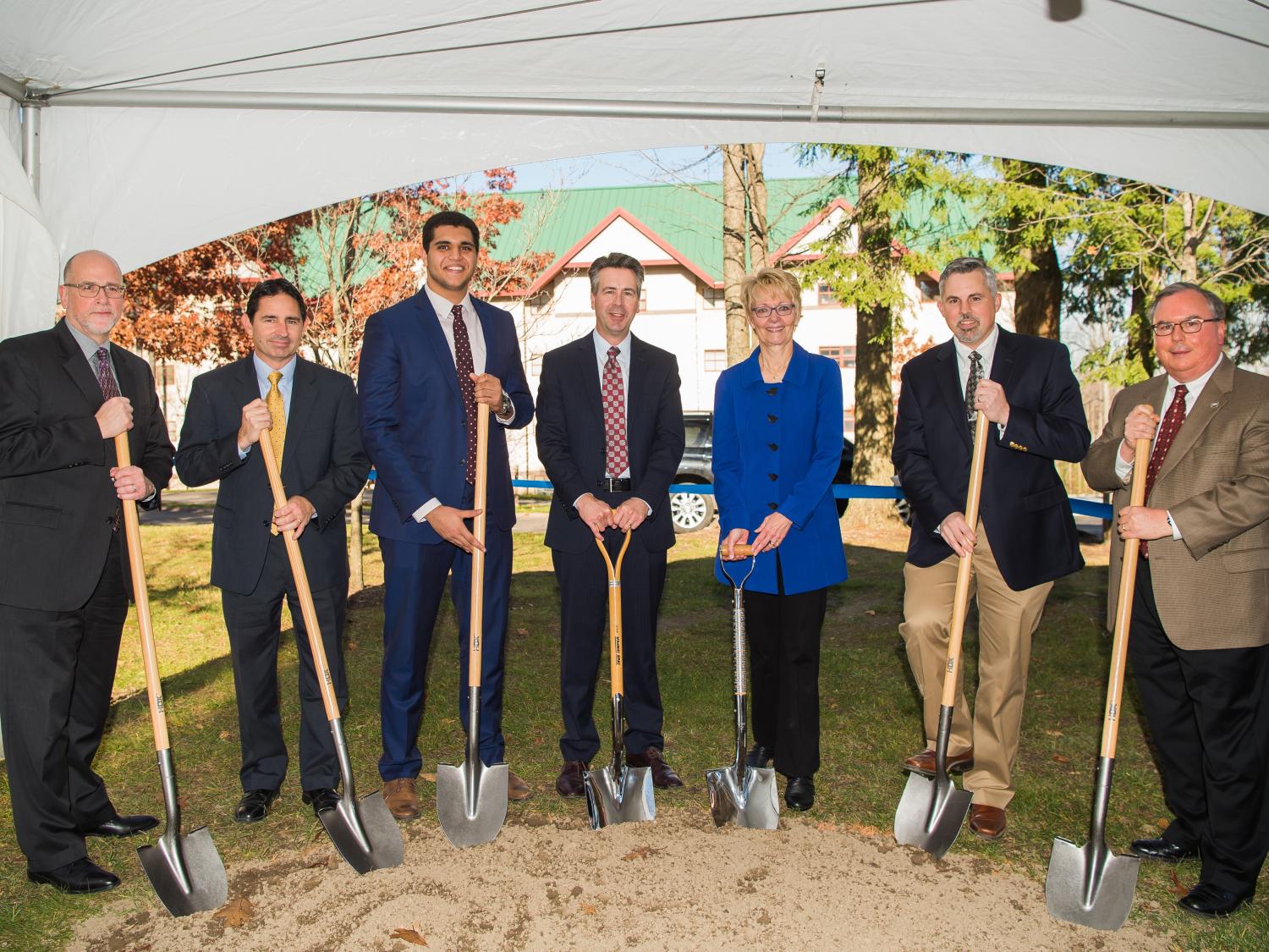 Guests with shovels prepare for the Trippe Hall groundbreaking ceremony at Penn State Behrend.