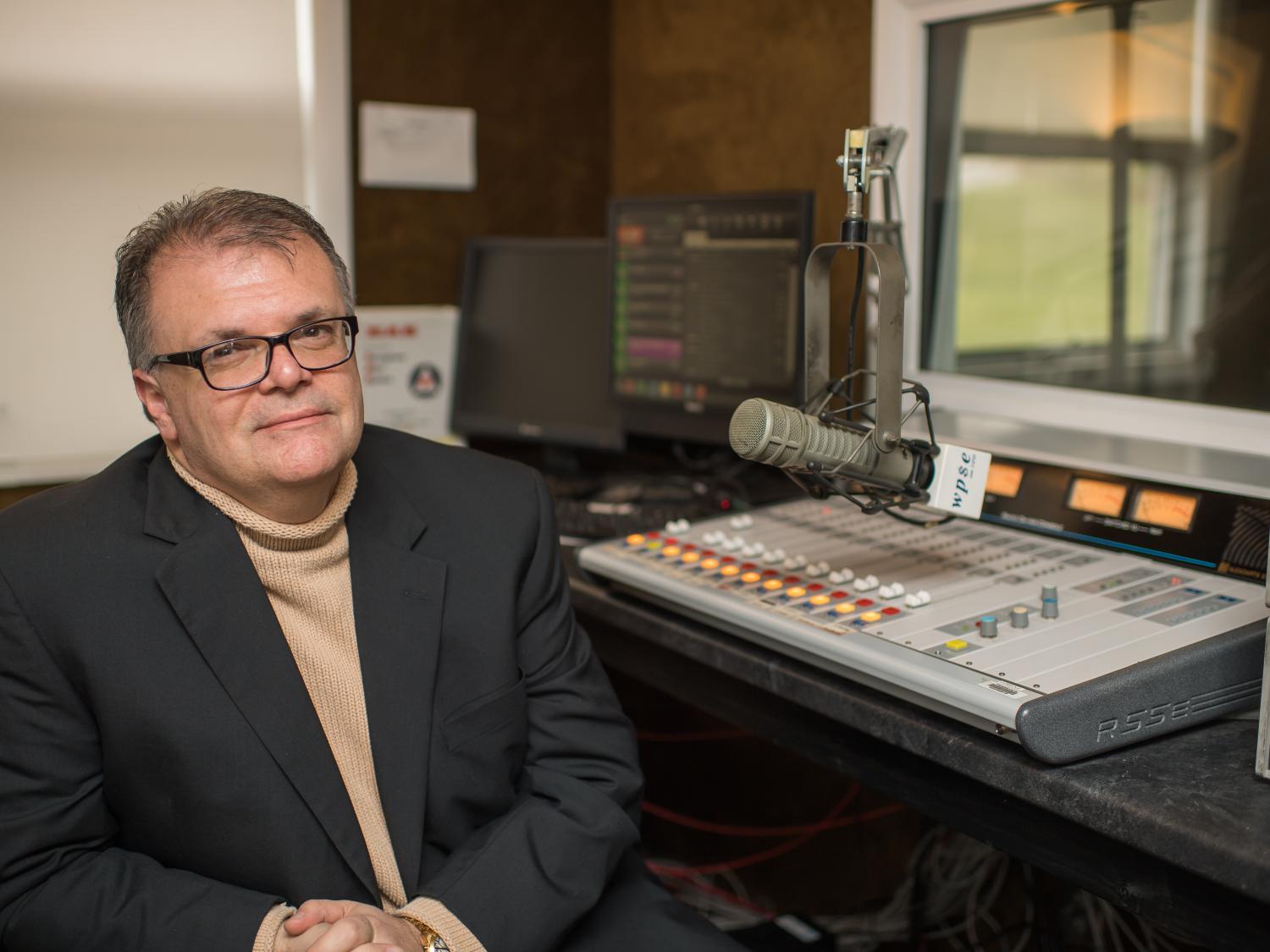 Joe Martin, the general manager of WPSE radio at Penn State Behrend, sits in the station's control room