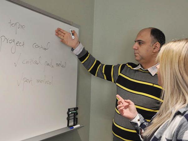 Instructor and student work together in classroom