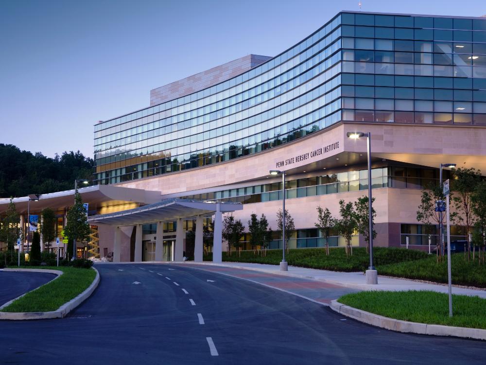 An external photo of Penn State Cancer Institute, taken from the driveway approach to the building.