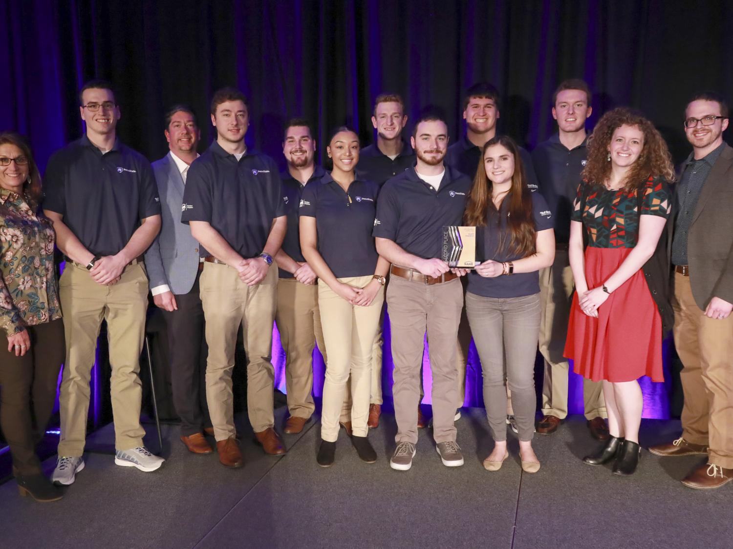 The 2019 Penn State NAHB Student Competition Team with PHRC staff on the IBS stage after winning second place. 