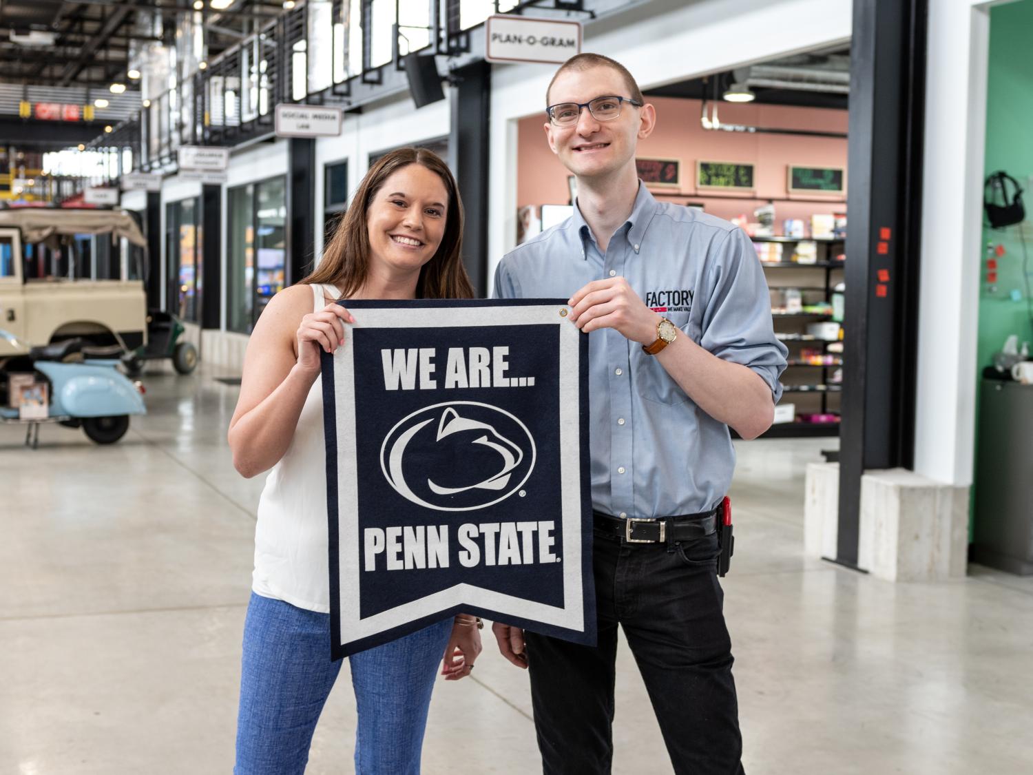 two people holding Penn State banner