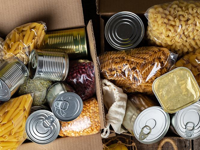 A box of pasta and canned foods