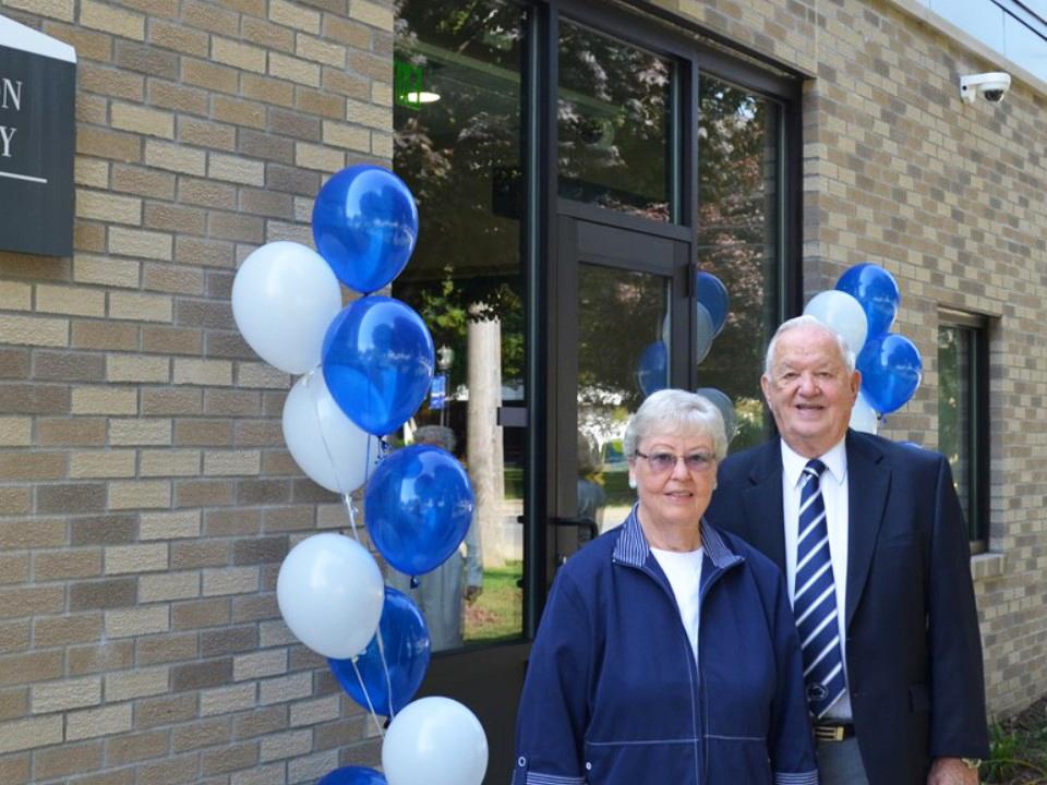 Paul and Eleanor Chadderton standing in front of the Chadderton Lab building on campus.