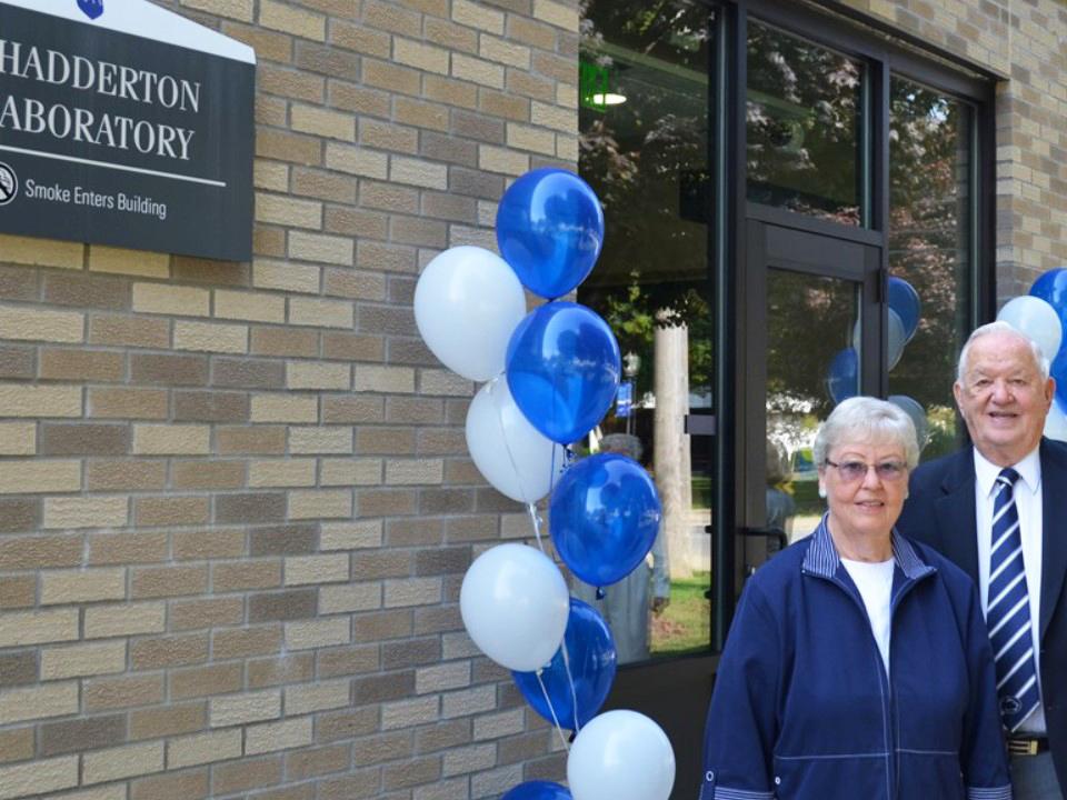 Paul and Eleanor Chadderton standing in front of the Chadderton Lab building on campus.