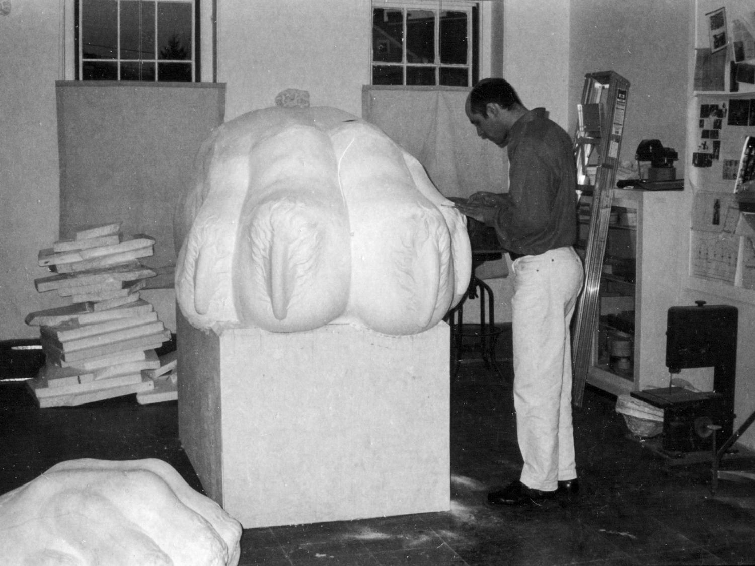 Paul Bowden working on lion paws sculpture for Palmer Museum
